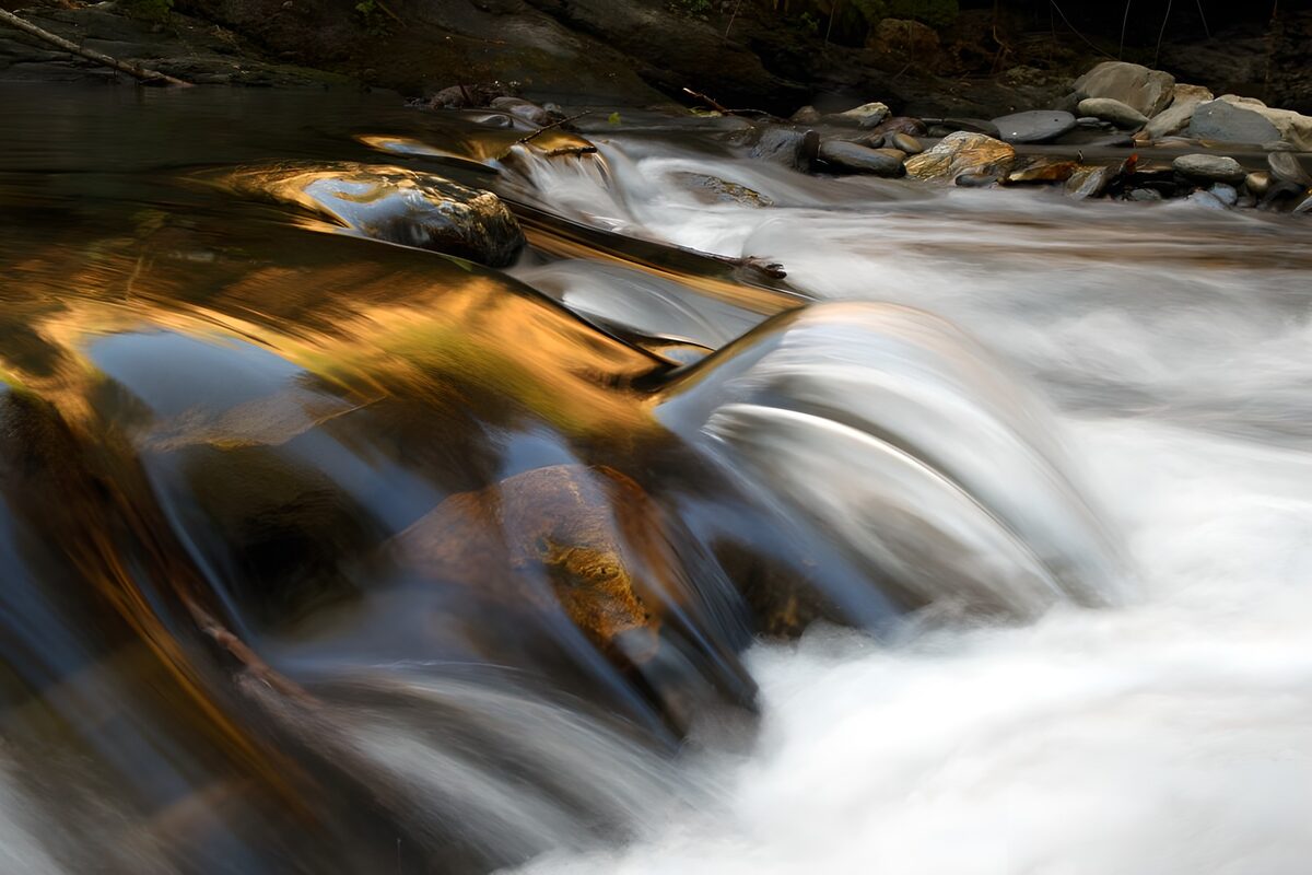Stromend Water met Gouden Reflecties